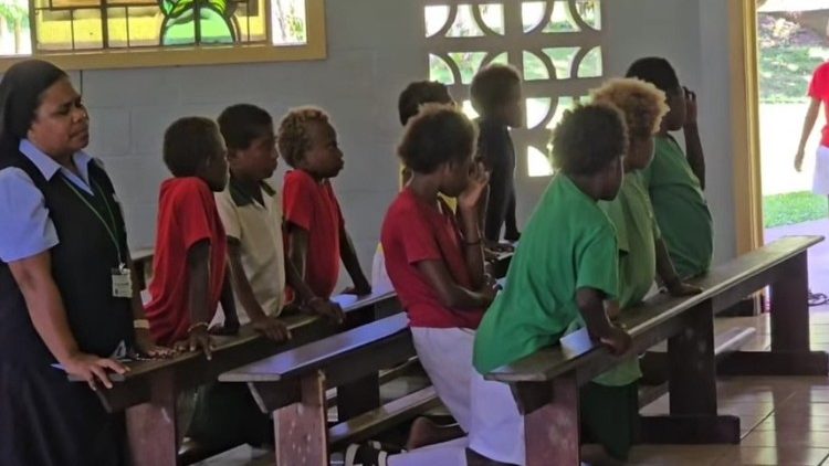 Children praying in the Shrine of Peter To Rot from the nearby school with Sr. Daisy