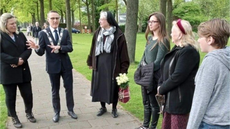 Sr. Madelene with a government official and some refugees