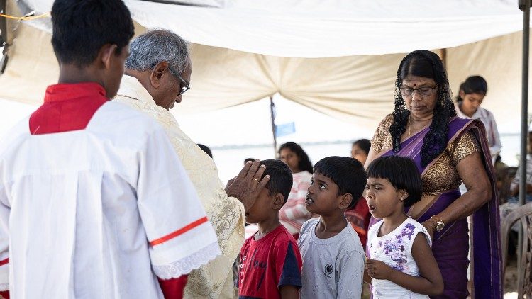 Fr Selvanayagam blesses some children during Holy Mass