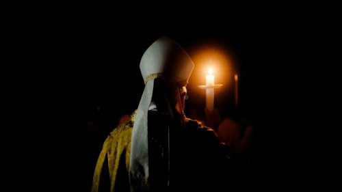 Archbishop Villegas holding a candle at prayer (Archdiocese of Lingayen-Dagupan)