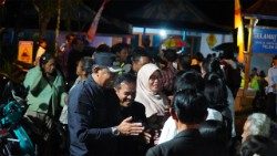 Sri Murtini, a Muslim village head, attentively oversees the Easter service, reflecting a shared commitment to harmony and mutual respect among communities.