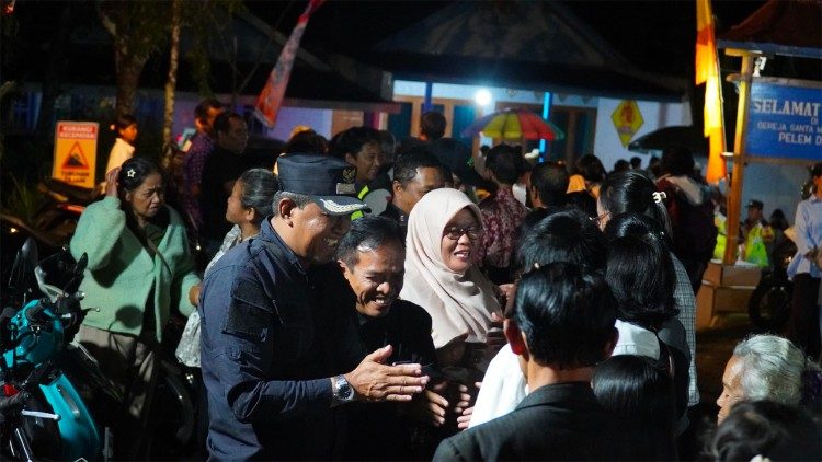 Sri Murtini, a Muslim village head, attentively oversees the Easter service, reflecting a shared commitment to harmony and mutual respect among communities.