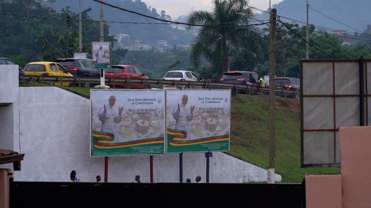Bilingual billboards in Yaound&eacute; read "May God Bless Cameroon"