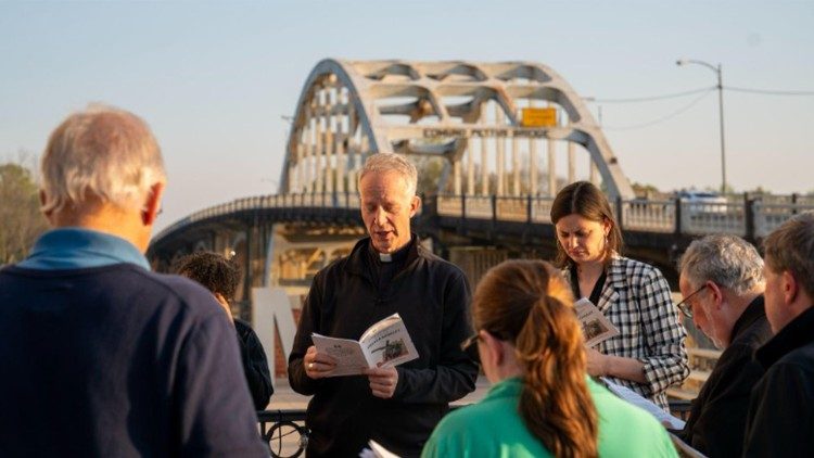Bishop William A. Wack leads the Stations of the Cross at the foot of the Edmund Pettus Bridge, the site of the infamous 1965 “Bloody Sunday,” when voting rights marchers traveling from Selma to Montgomery were attacked by police.