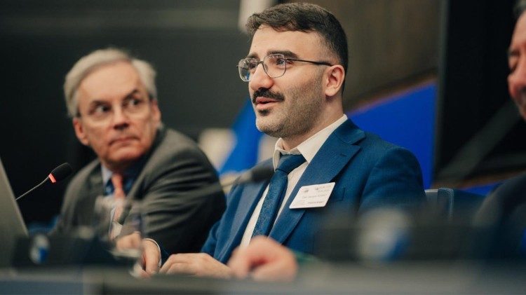Dilan Adamat, centre, speaking at the European Parliament